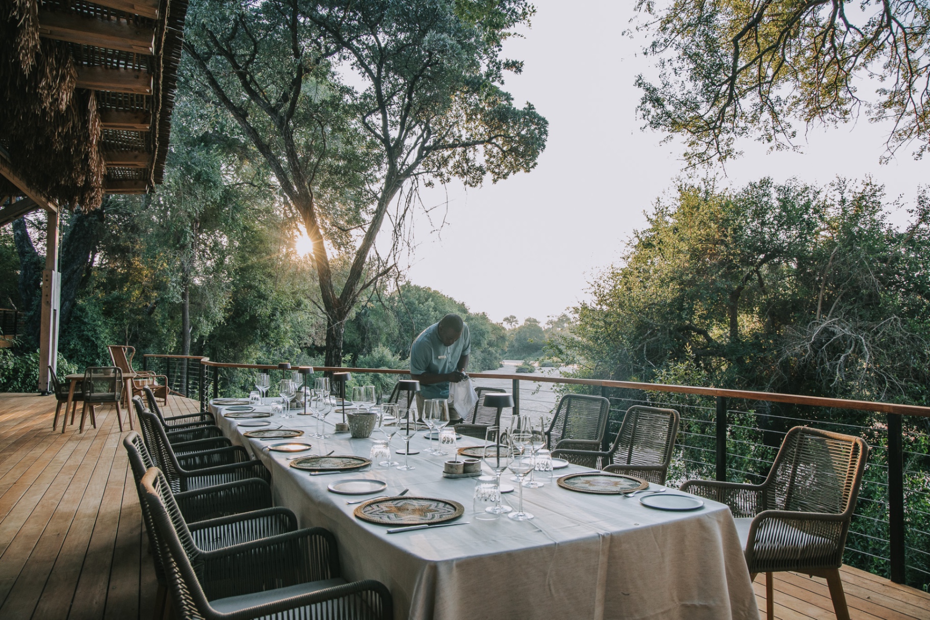 Riverside dinner setup at sunset